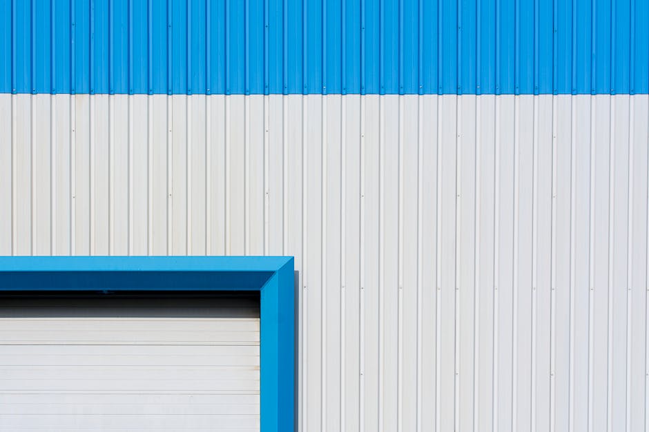 Adelaide technician repairing a residential roller garage door — replacement curtain slats and motor housing